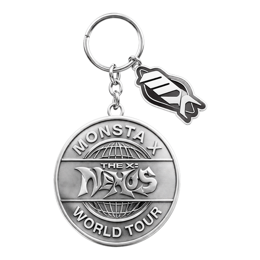 A silver-toned metal keychain featuring a round commemorative medallion with 'MONSTA THE X-NEXUS WORLD TOUR' text and a small dangling MX-shaped charm, shown on a plain white background.